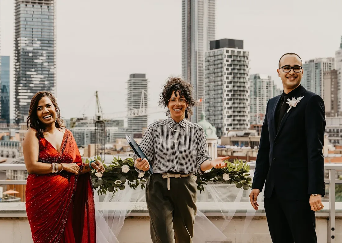 A rooftop wedding ceremony with the Toronto skyline behind
